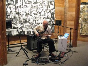 Lez-Playing-Guitar-at-the-Opening-of-his-Paintings-Exhibition